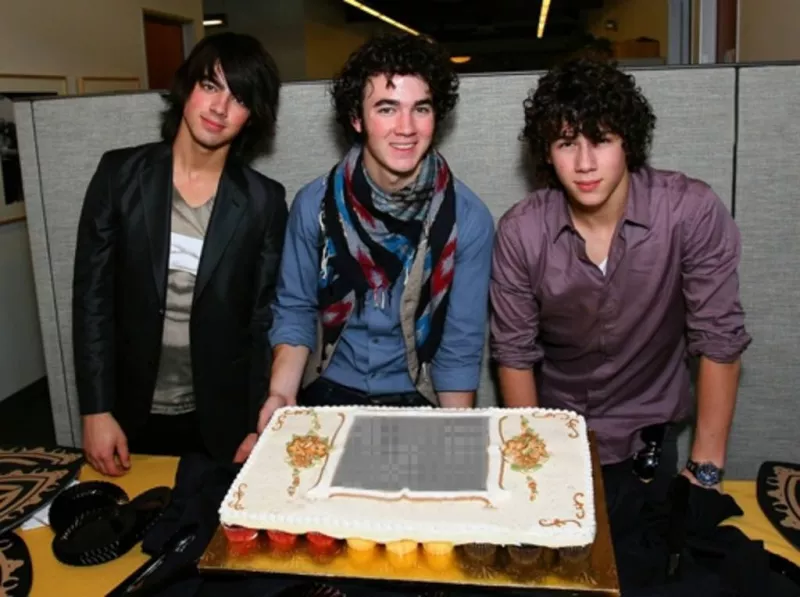 Entrar para entrar em uma festa dos Jonas Brothers em uma maneira especial. Fotomontagem na sua foto é exibida em uma torta depois de posar Kevin, Joe e Nick, os três irmãos dos membros boy band, comprada pela Disney..